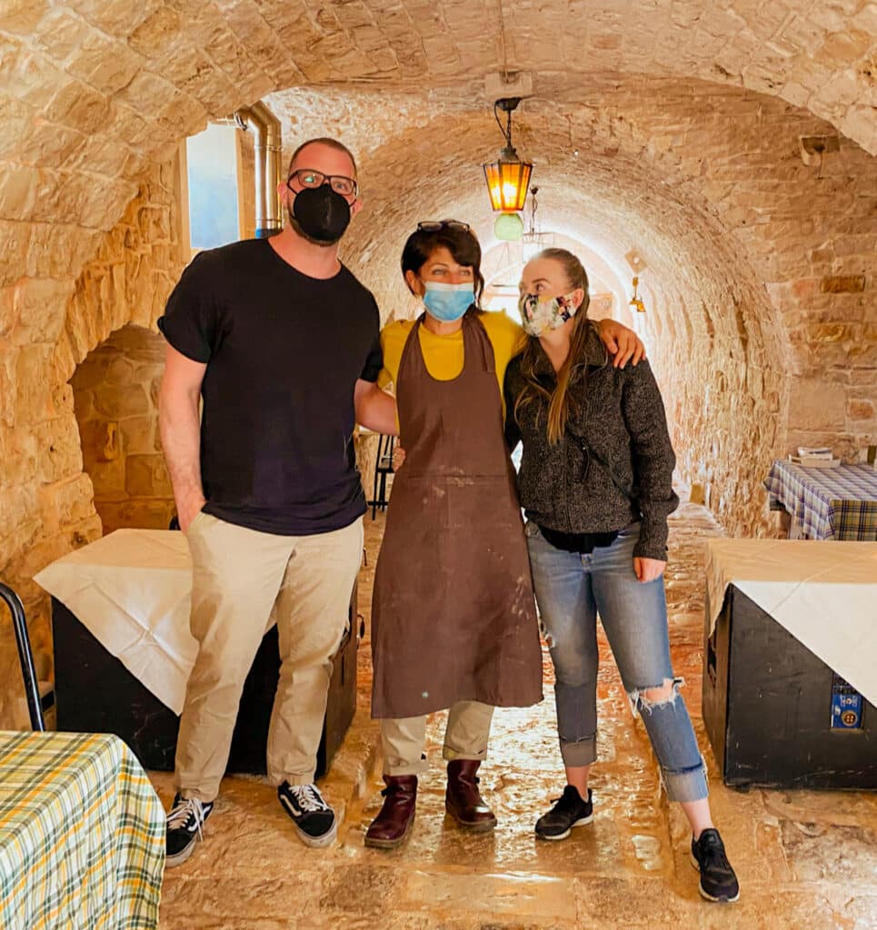 Jillian travel and wellness influencer and blogger at a cooking class in Alberobello with the chef and her partner