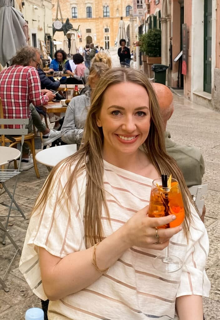 jillian travel and wellness influencer enjoying la dolce vita and an aperol spritz in italy