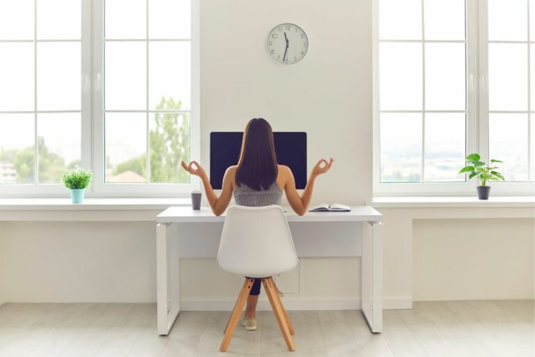woman at desk in the office embracing the anti hustle movement