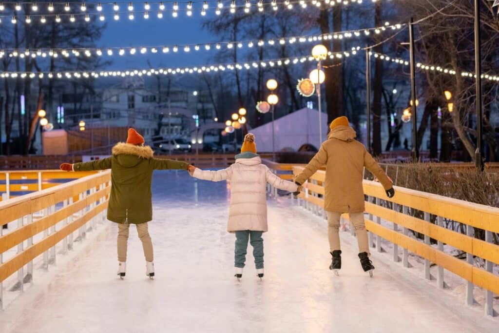 family ice skating at christmas time