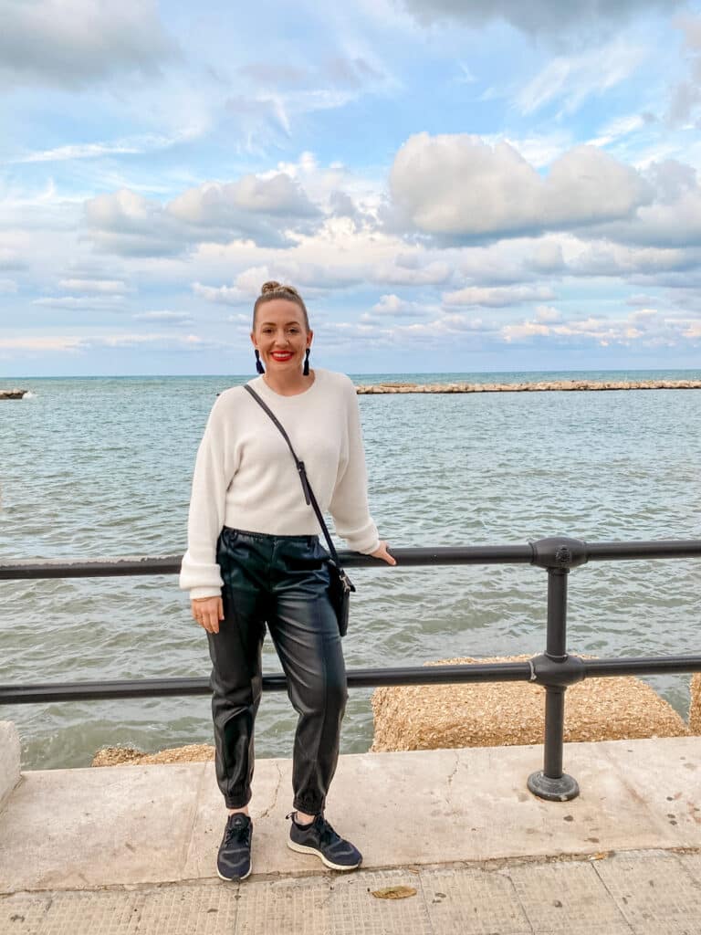 Jillian, travel influencer, on the coast in Bari, Puglia, Italy