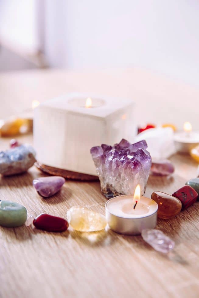 crystals and candles being used in manifestation practice